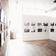 Uptown Art Gallery with open floor plan, hardwood floors, brick walls, and ample lighting